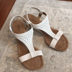 White sandals with small heel.